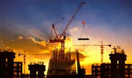 Big crane and building construction against dusky sky